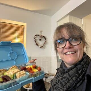 caroline job lunch box lady holds healthy colourful lunch box