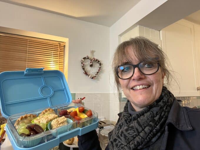 caroline job lunch box lady holds healthy colourful lunch box 